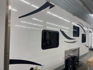 Exterior of white camper with black and grey design.